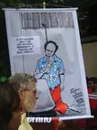 Carlos Latuff political cartoon poster about the military dictatorship in Brazil held by a group of people