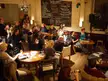 Dirty Black Shirts performing at the 18. Detmolder Ohrenschmaus in the Wohnzimmer, with a group of people and a chalkboard