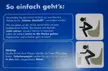Female urinal instructional sign with black silhouettes of women and German text