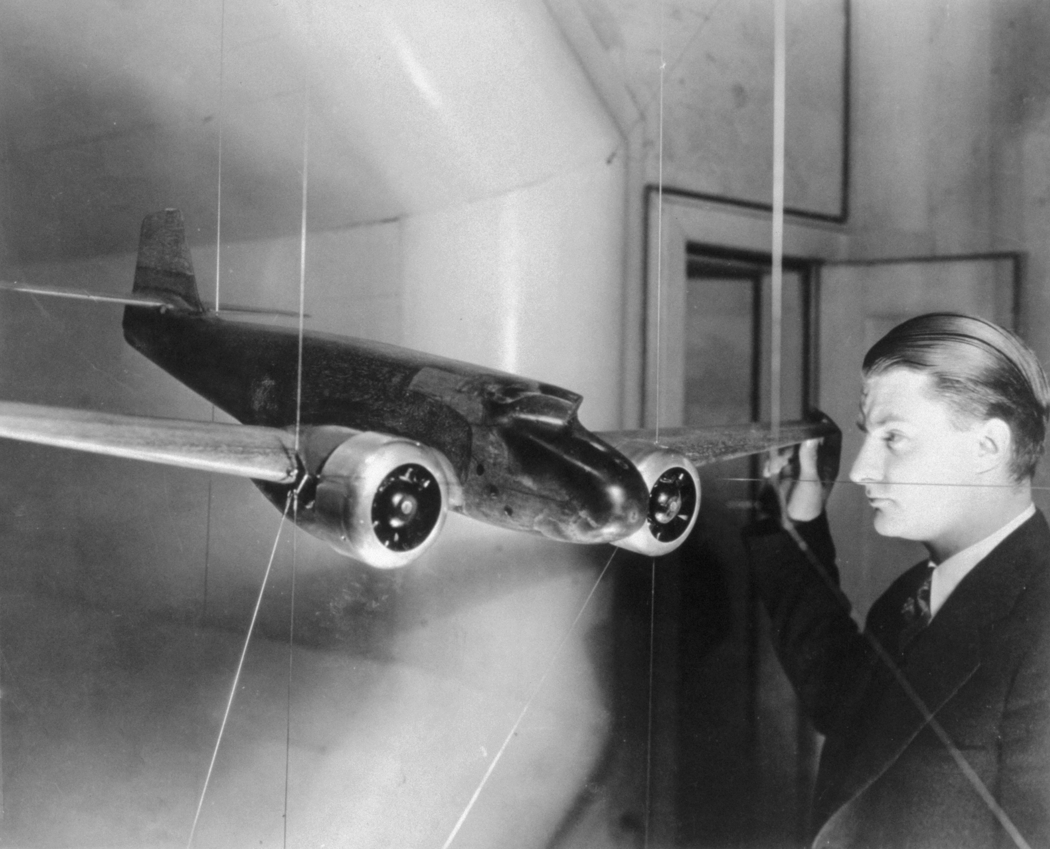 Clarence "Kelly" Johnson is testing an Electra model with single vertical tail and forward-sloping windshield in the University of Michigan's wind tunnel.