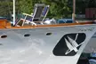 Close-up of a vintage white boat with wooden trim and deck chairs for a retirement cruise