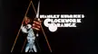 A Clockwork Orange movie title screen with a man holding a knife in an orange triangle and a woman below
