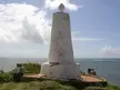 Padrão of Vasco da Gama, a white conical monument with a cross on a coastal cliffside in Malindi, Kenya