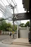 Slender Asian girl in a white t-shirt and black short skirt with a backpack at Kbaan K serviced residence