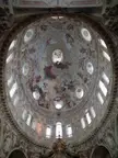 Ornate dome ceiling with religious frescoes and architectural moldings at the Sanctuary of Vicoforte in Italy