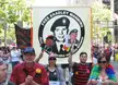 LGBTQ people from Oklahoma in streetwear and casual clothes holding banners for Bradley Manning on a city street