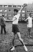 Halina Konopacka in athletic wear preparing to throw a disc at the 1928 Summer Olympics
