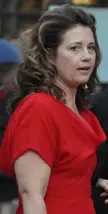Princess Alexia wearing a red dress with long wavy brown hair and fair skin.