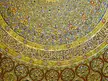 Dome of the Rock architectural detail with gold, blue, and red Islamic geometric patterns and Arabic calligraphy