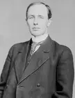 Arthur Meighen in a black and white vintage photo, wearing a dark double-breasted suit and patterned tie