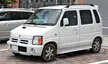 White Suzuki Wagon R-Wide pre-facelift JDM car parked in a lot next to a silver vehicle.