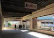 Asian girls in casual streetwear and denim jeans walking through a corridor toward the Bandar Utama MRT station sign.