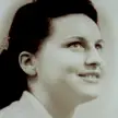 Jacqueline Fleury in a close-up, sepia-toned vintage photo with dark hair styled up and pale skin.
