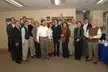 InsideOut 02: a group of 15 smiling people in business casual attire, including white shirts and cardigans, in an office
