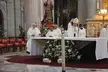 Cardenal Primado de Mexico Norberto Rivera Carrera and priests in white vestments at a cathedral altar