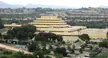 The Chet Holifield Federal Building, a tiered yellow building, in a suburban valley of Laguna Niguel and Aliso Viejo