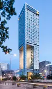 Tallest buildings in Poland featuring a modern glass skyscraper with a cutout section against a blue sky