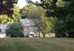 Edward Beale House, a colonial revival architecture stone home with a grey roof and lush green lawn
