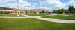Michigan State Historic Sites in Marquette County featuring brick buildings, green lawns, and concrete paths.