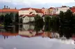 Colorful buildings with red roofs reflected in a calm river in Pisek, beautiful landscape photography
