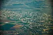 Vintage aerial photo of Kiryat Ata showing city buildings, roads, and agricultural fields.