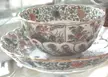 Chinese porcelain piyāla with a floral print from the Qing dynasty resting on a matching saucer