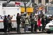 Photographers and journalists in winter clothing by a broadcast vehicle at the Soongryemun Gate fire disaster