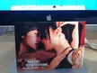 Two Asian lesbian friends, one in a black dress and one in a white lace top, on a promotional card for Holebi Filmfestival