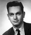 University of Florida yearbook photo of a man with dark hair and pale skin in a black and white close-up