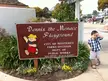 Vintage family photo of a boy in a checkered shirt by the Dennis the Menace Playground sign in Monterey