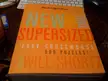 New York Times supersized book of easy crosswords on a wooden pc gaming desk setup next to a keyboard
