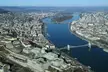 Strike Back TV series cityscape with a wide river, bridges, and mountains in the background