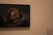 A white couple in an intimate embrace, woman in a grey bra and man in blue jeans, art by Nan Goldin.